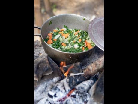 ‘Love, patience and effort,’ Miss Belinda shares, are the qualities she possesses in order to deliver her remarkable meals, including this pot of pak choi and carrots slow-cooked on a wooden flame. 
