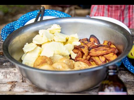 Sides galore! A perfect combination of Jamaican-style sides, fried breadfruit, fried plantains and fried dumplings, ready for your choosing, served at Miss Belinda’s Riverside Restaurant in Portland. 