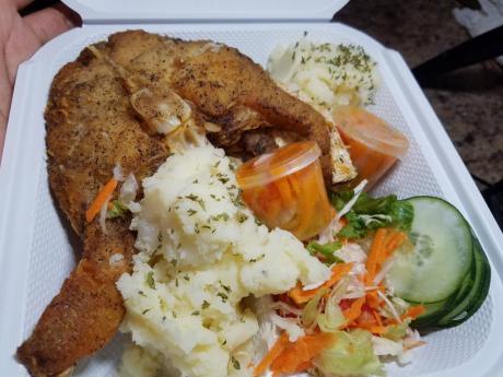  Escovitch fish served with a side of mashed potatoes and vegetables. 