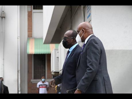 
Ruel Reid (left), former education minister, and Fritz Pinnock, the in-limbo president of the Caribbean Maritime University, leaving the Kingston and St Andrew Parish Court last week. The multimillion-dollar fraud case involving both was adjourned until M