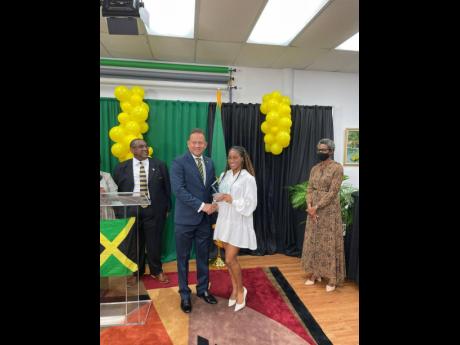 Jamaica’s Olympic sprint relay gold medallist, Briana Williams (second right), is presented with the Consulate General of Jamaica Heritage Award by Consul General, Jamaica, to Southern United States, Oliver Mair (second left), on Sunday.