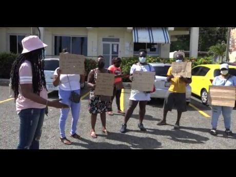 Unpaid contract workers from Islington, St Mary, protesting outside the Municipal Corporation building in Port Maria.