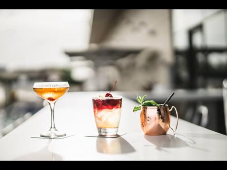 The cocktails at AC Hotel Kingston are aesthetically pleasing using local spirits and herbs to garnish. They are (from left) the explorer martini, the New York sour, and the Kingston mule. 