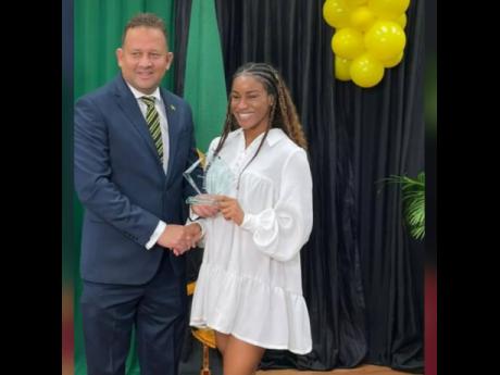 Jamaica’s Consul General to Miami, Oliver Mair, congratulates Jamaican Olympian Briana Williams after she received the Heritage Award.