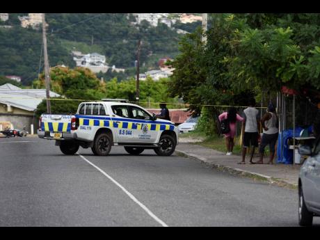 Police investigators cordon off the intersection of Shorton Drive and Molynes Road in St Andrew after a motorcyclist, 28-year-old Damique Mullings, was shot dead by unknown assailants.