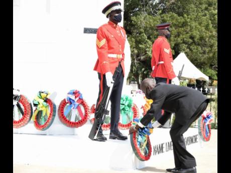 Lt Col Andrew Sewell, chairman of the Jamaica Legion, lays a wreath at the War Memorial at the National Heroes Park yesterday in honour of World Wars I and II veterans as part of activities to mark Remembrance Day.