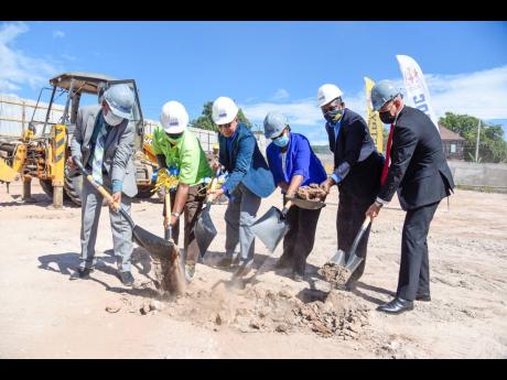Deputy Prime Minister and Minister of National Security Dr Horace Chang (third left) breaks ground for the construction of a state-of-the-art forensic pathology autopsy suite at 149 Orange Street, downtown Kingston, on Friday. Joining him (from left) are M
