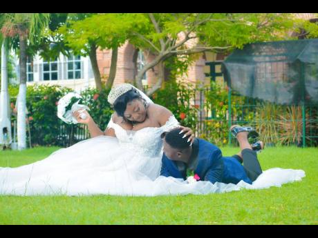 The lovers enjoy a moment to themselves, lying in the grass on their wedding day.