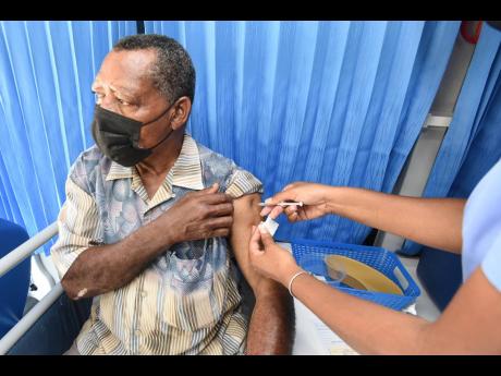 Robert Nelson gets his second dose of the Pfizer vaccine during a vaccination blitz in Port Royal on Saturday.