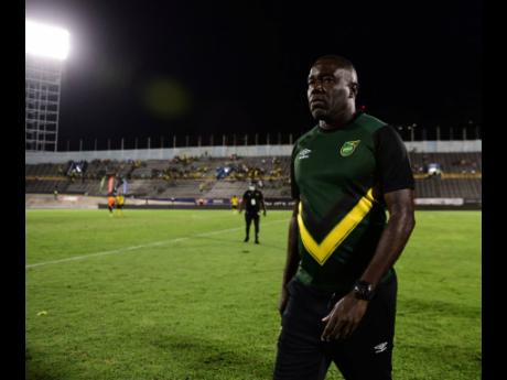 Reggae Boyz coach Theodore Whitmore casts an unhappy figure after his side only managed a point against the United States inside the National Stadium on Tuesday night.