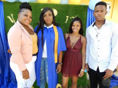 Ashante Whitfield is flanked by (from left), mom Yanique Hall, friend Sammoy Cunningham and brother Aaron Whitfield 