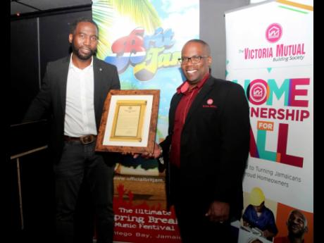 Khori Hyde (left) director of BritJam shares the citation with Leighton Smith, chief representative officer for Victoria Mutual Building Society, one of the major sponsors at a reception inside the Ritzy Bar in Brixton, south London.