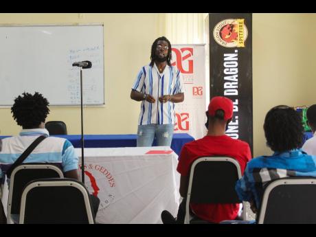 Recording artiste Yaksta reasons on ambition and assets with at-risk youths of the Windsor Farm training programme.