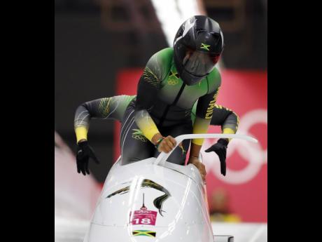 Driver Jazmine Fenlator-Victorian and Carrie Russell of Jamaica start their first heat during the women’s two-man bobsled competition at the 2018 Winter Olympics in Pyeongchang, South Korea. Coach of the Jamaica team, Wayne Thomas, says better equipment 