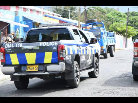 Police patrol a section of Franklyn Town on November 13, the first day of new states of emergency in seven police divisions. 