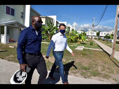 William Lai (right), developer of the Foreshore Estate, takes Minister of Housing, Urban Renewal, Environment and Climate Change Pearnel Charles Jr on a tour of the developments last Friday.