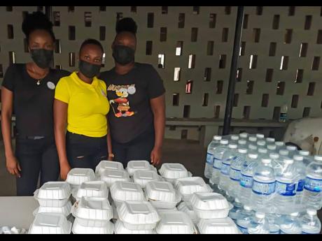From left: Alecia Edwards, Jameley Brown, Britney Hinds with some of the lunches and bottles of water donated.