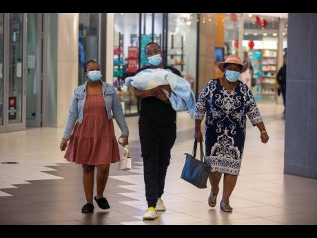 People with masks at a shopping mall in Johannesburg, South Africa yesterday. 