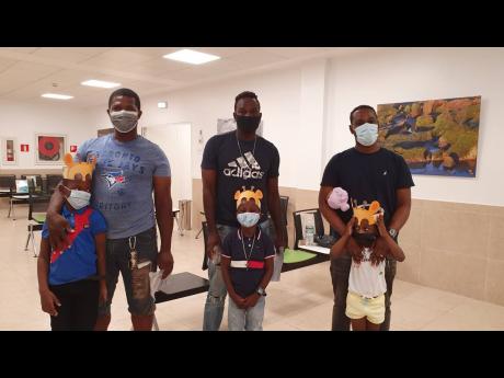 From left: Talvert Smith and son Wyett; Horatio Brown and son Horatio Jr; and Gervon Thomas and daughter Kadayja at the Hospiten Montego Bay back-to-school medical camp recently.