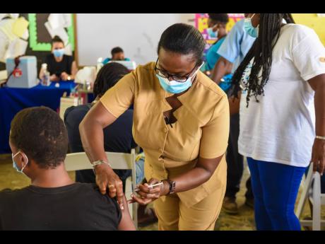 A resident receives a dose of a COVID-19 vaccine at the Petersfield Primary School in Westmoreland recently. The vaccination site was organised by the JN Foundation with support from American Friends of Jamaica. Physicians have urged Jamaicans that current