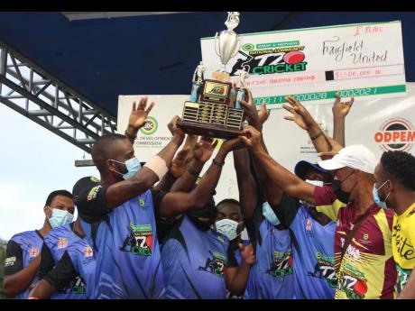 Fairfield United hoist the SDC trophy after beating Race Course in the final at Noranda Cricket Ground in Discovery Bay, St Ann, yesterday.