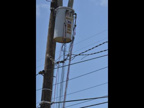 A web of illegal throw-up lines are seen connected to Jamaica Public Service Company equipment in New Haven, St Andrew. Power theft costs the company more than US$220 million annually. 