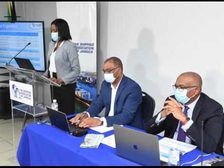 SAJ President William Brown (seated at right) with Group CEO Trevor Riley as Fiona Hall, operations manager, finance, presents the company’s financial statements.
