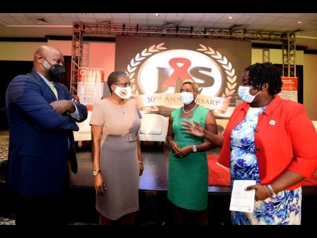 Kandasi Levermore (right), executive director of Jamaica AIDS Support for Life, speaks with Juliet Cuthbert Flynn (second right), state minister for health and wellness, Dr Jennifer Brown-Tomlinson, medical director of JASL, and Jason Fraser, country repre