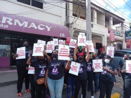 A group of women with placards voice their concern against violence against women, in May Pen, Clarendon. They are demanding action to be taken to protect women and ensure speedy justice is given to victims of violence. 