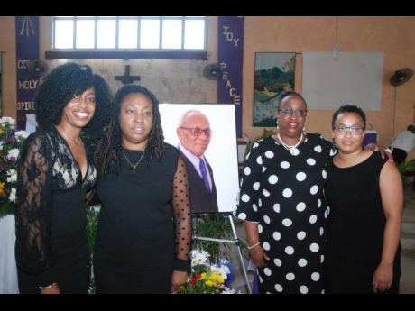 From left: Daughters Chevonne Parkes-Williams, Janell Parkes-Walker, Lois Parkes, and Farrah Parkes pose with a picture of their father, the late Wilbert Parkes, after his funeral service at the St Paul’s Anglican Church in Portmore, St Catherine on Frid