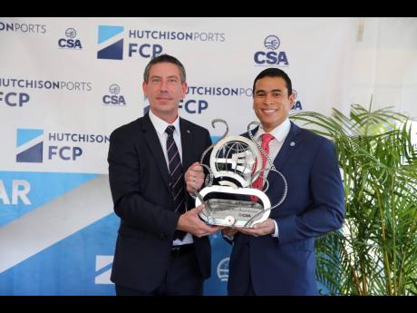 President of the Caribbean Shipping Association Juan Carlos Croston (right) presents the award for Container Port of the Year to Freeport Container Port CEO Alan Dixon.
