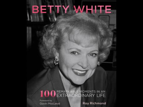 This cover image released by becker&mayer! shows ‘Betty White: 100 Remarkable Moments in an Extraordinary Life’.