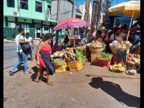 Vendors outside the gate of the Mandeville Market. 