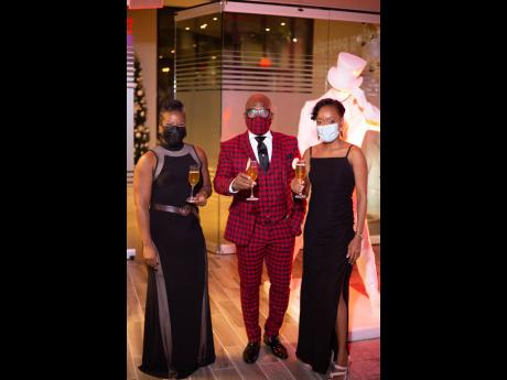 From left: Teika Samuda, spirits consultant; Carlton Brown, men’s fashion designer; and Lyshon Davis, brand manager, Johnnie Walker, enjoy a signature cocktail, the Golden Apple – Johnnie Walker Gold Label mixed with apple juice, clear syrup, and a hin