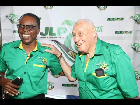 Lester Michael Henry (right), member of parliament for Clarendon Central, has a light moment with Joel Williams, councillor for the Denbigh division, during the Jamaica Labour Party’s 78th annual conference at the Denbigh Showground, one of 10 remote sit