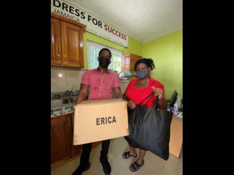 Bradley Richards (left) hands over Erica-branded boxes to a representative of the Dress For Success organisation.