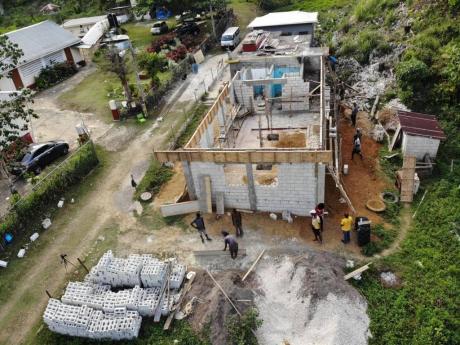 Construction work under way on the St Elizabeth-based Quickstep Basic School, a $7-million rehabilitation project by Pencils4Kids. At left is the Quickstep Primary School.