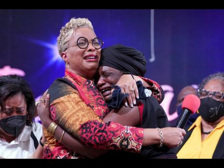 The Rev. Gina Stewart (left), senior pastor of Christ Missionary Baptist Church, comforts Hatshepsut Bandele during a church service last week in Memphis, Tennessee. “Whenever a woman is placed in a role that is traditionally male, there’s always some 