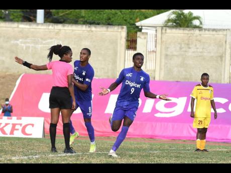 
Kingston College’s Ronardo Burger (No. 9) celebrates after scoring his team’s second goal during their ISSA/Manning Cup football match against Charlie Smith High School at Stadium East playing field yesterday. KC won 3-0.