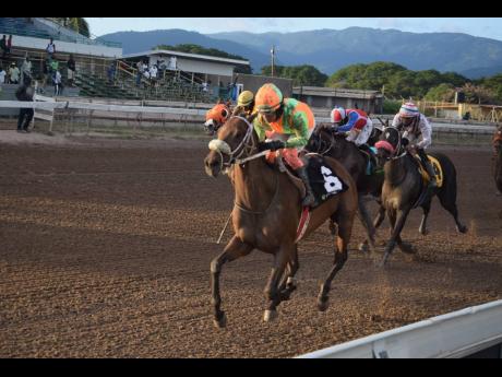 LABAN, ridden by Abigail Able, wins the Ahwhofah Sprint Trophy over six furlongs at Caymanas Park yesterday.