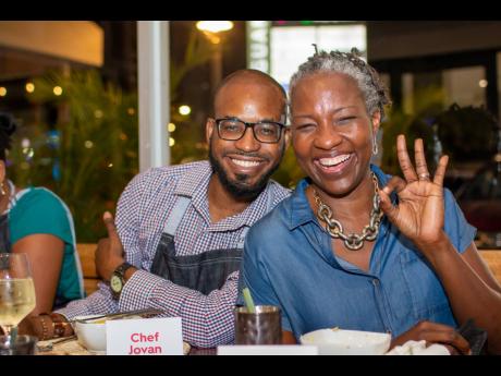 Jovan Johnson, senior staff reporter, The Gleaner, and chef-for-a-day, takes a break from the stove to pose for a picture with RJRGLEANER’s Paula-Anne Porter-Jones.