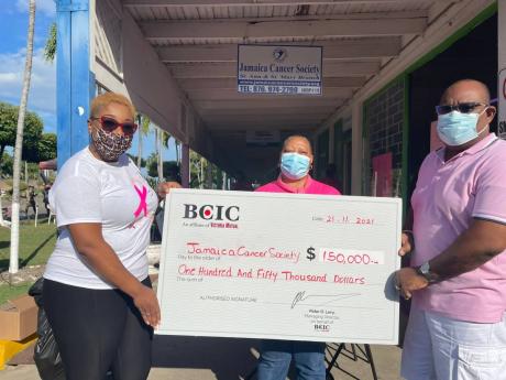 Trecia Larmond (left), branch supervisor, BCIC Ocho Rios, makes a cheque presentation to the Jamaica Cancer Society (JCS) team of Executive Director Michael Leslie (right) and Marilyn Williams, St Ann/St Mary branch manager. A gold sponsor, BCIC made the $