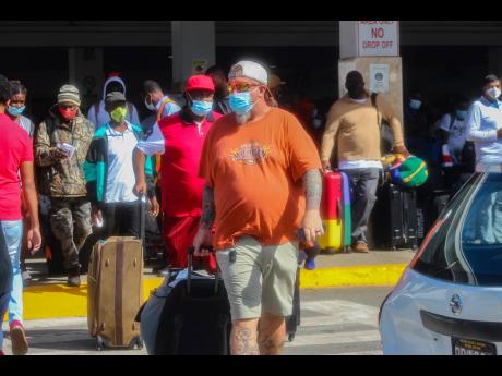 Visitors arrive at Sangster International Airport in Montego Bay, St James, on Wednesday, December 15, the beginning of the winter tourist season.
