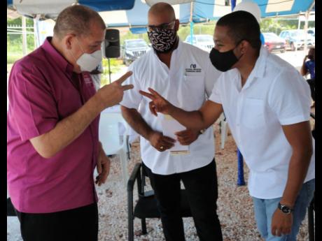 Minister of Agriculture Audley Shaw (left) and Floyd Green (right), member of parliament for St Elizabeth South Western, exchange pleasantries before the start of the official commissioning of the National Irrigation Commission’s Little Park Pump station