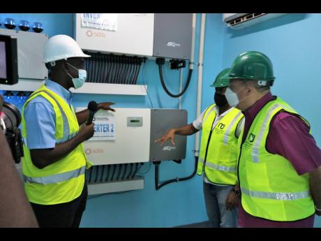 Project Manager Emile Myers fields a question from St Elizabeth South Western Member of Parliament Floyd Green and Minister of Agriculture Audley Shaw during their tour of the inverter room of the Little Park pump station in St Elizabeth on Thursday.