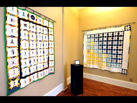 Two hand crafted quilts adorned with 116 cross-stitched portraits honouring African Americans who lost their lives to racial violence are photographed while on display at the Margaret Walker Center on the Jackson State University campus, Tuesday, Nov. 30, 