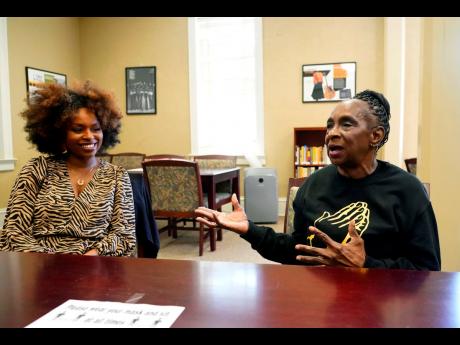 Gloria Green-McCray, right, sister of James Earl Green, who along with Phillip Lafayette Gibbs was killed by Mississippi Highway Patrolmen in 1970 on the campus of Jackson State University, discusses the importance quilting plays in the African American co