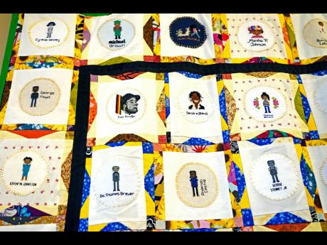 A section of two hand crafted quilts adorned with more than 115 cross-stitched portraits honouring African Americans who lost their lives to racial violence, is photographed while on display at the Margaret Walker Center on the Jackson State University cam