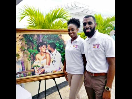 
Shauna and Cory Anderson of Canvas JA with a canvas print from their wedding day.