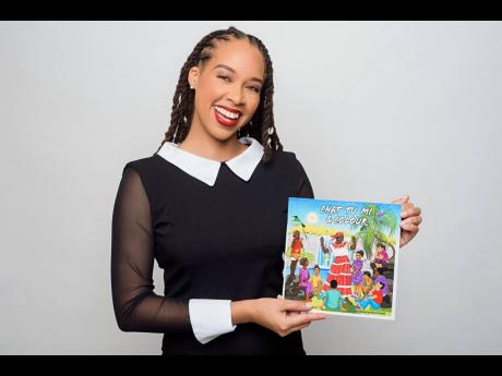 
Amashika Lorne with her ‘Chat Tu Mi & Colour’ book for children.